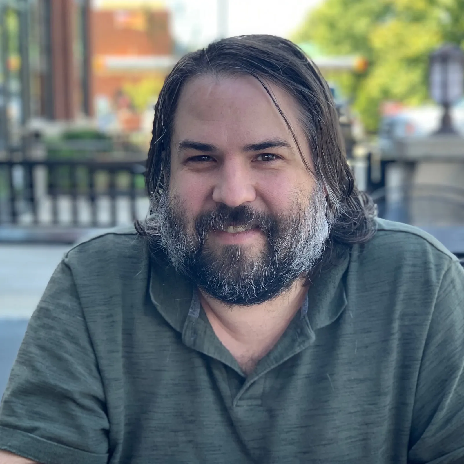 Micah Hurst, smiling at an outdoor café table